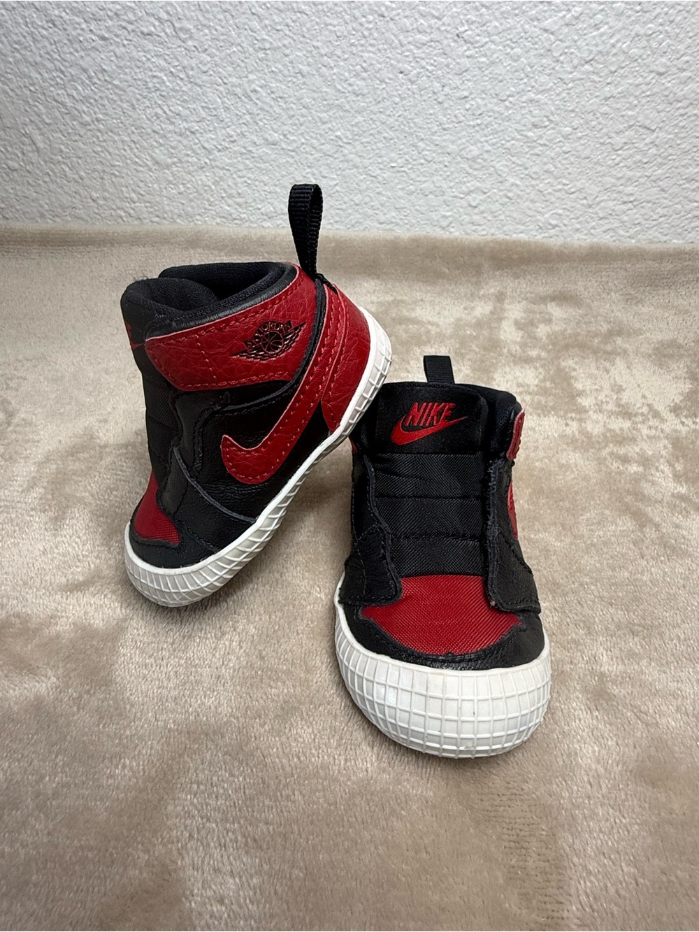 Nike Air Jordan 1 Crib Bootie infant shoes in the black and varsity red "Bred"